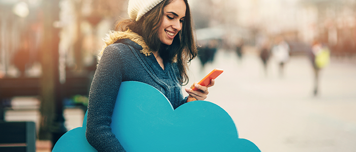 Woman using phone with cloud symbol, representing cloud security in Chicago